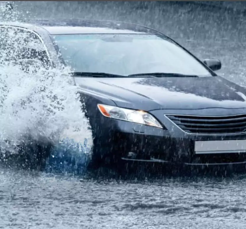 Car driving in heavy rain with RAINAWAY wiper blades